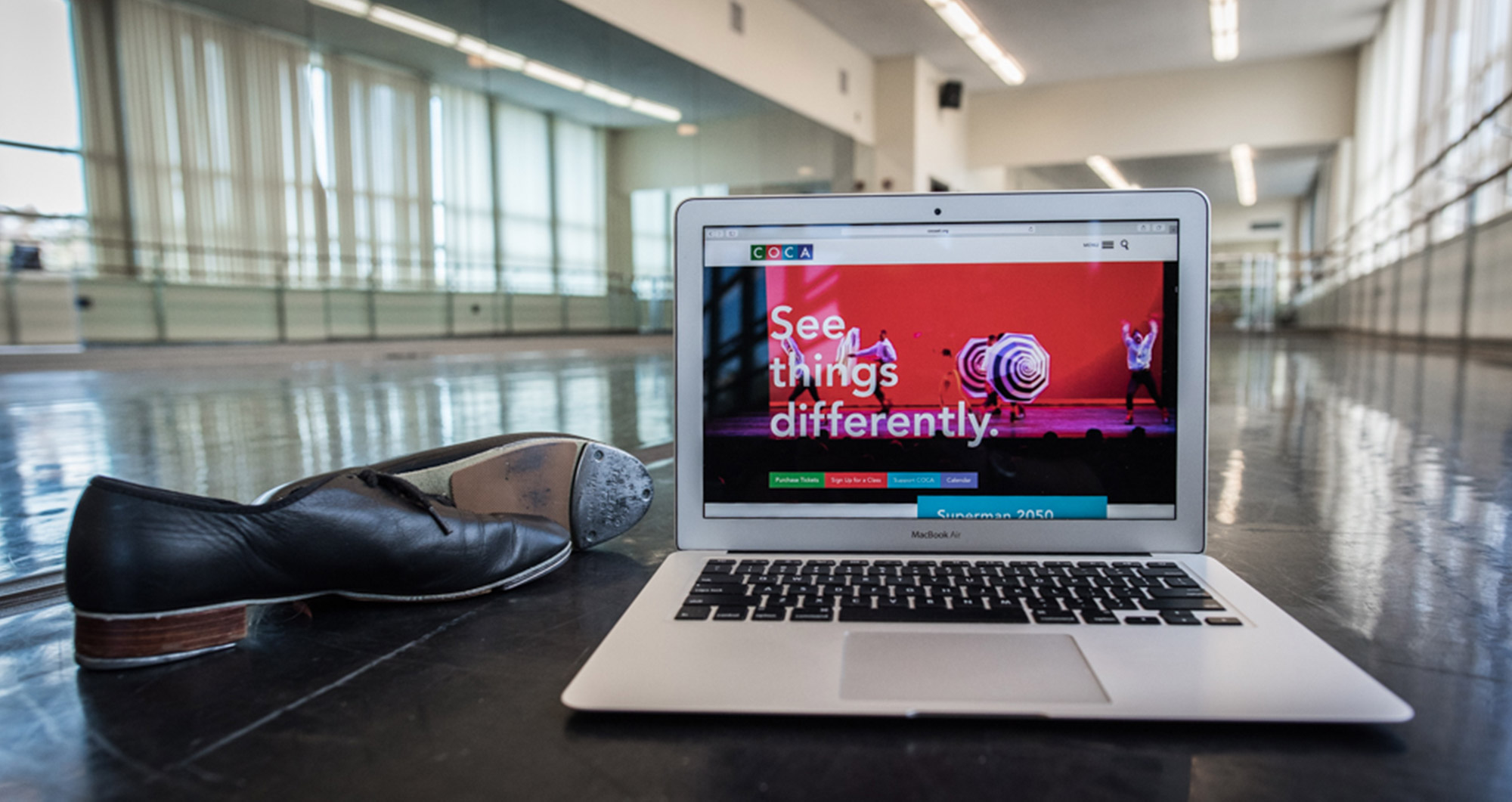 COCA Website Design - Laptop on the dance floor