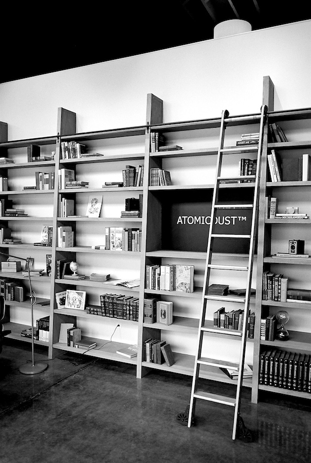 The bookshelf in the lobby of Atomicdust - Branding and Design Agency in St. Louis