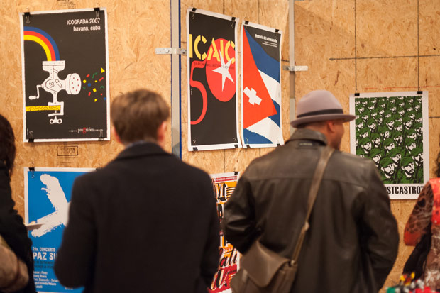 Guest admiring the work at the Cuban Poster Design Exhibit at Atomicdust