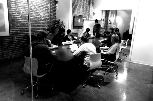 The creative team at Atomicdust gather around the conference table.