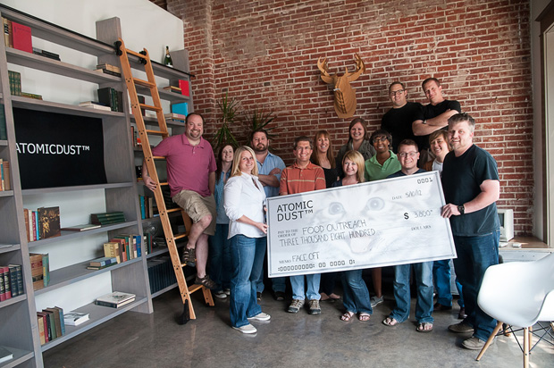 Atomicdust presenting Food Outreach with a giant cat check.