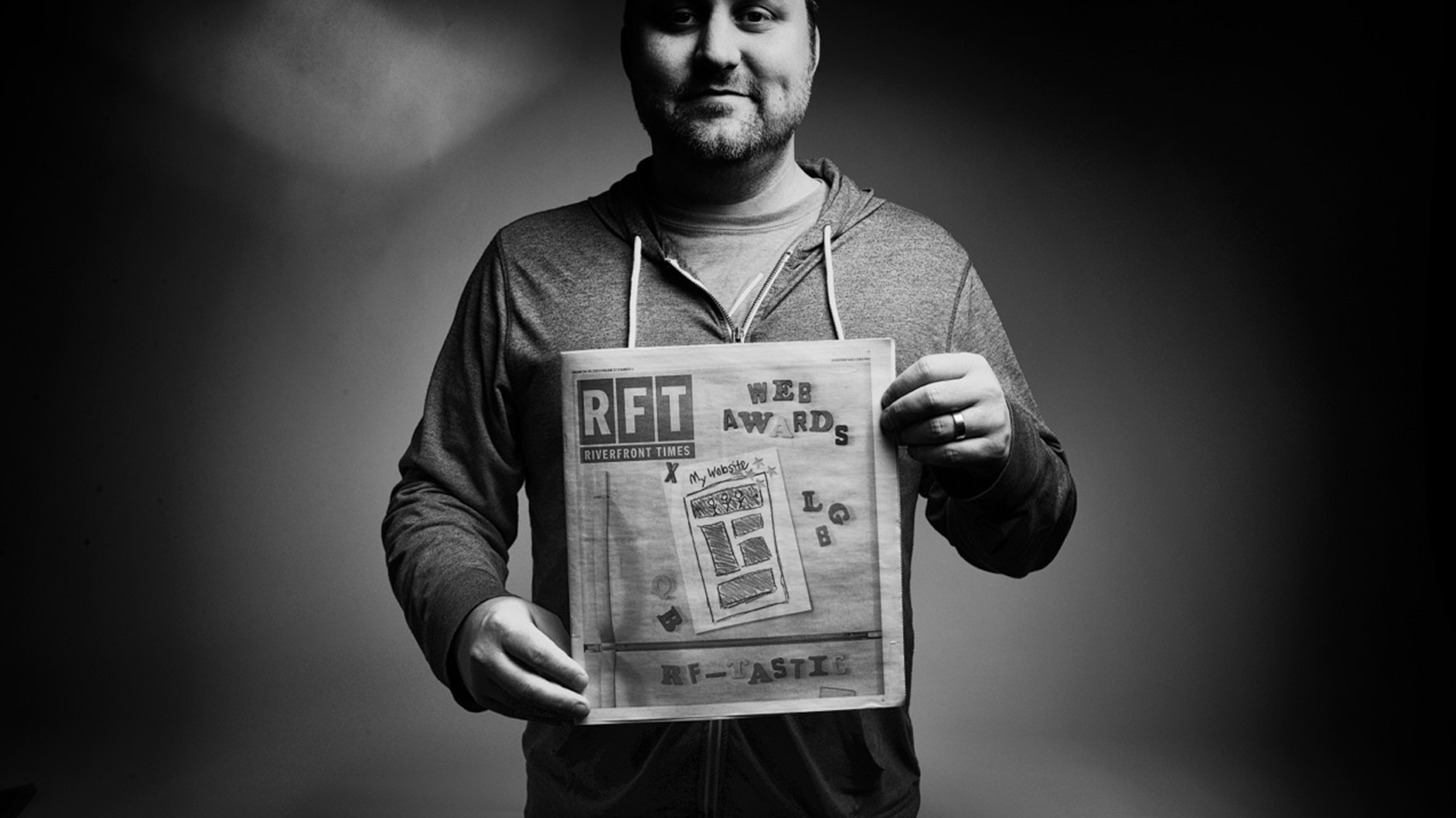 Mike Spakowski hold a copy of the RFT newspaper awards issue.