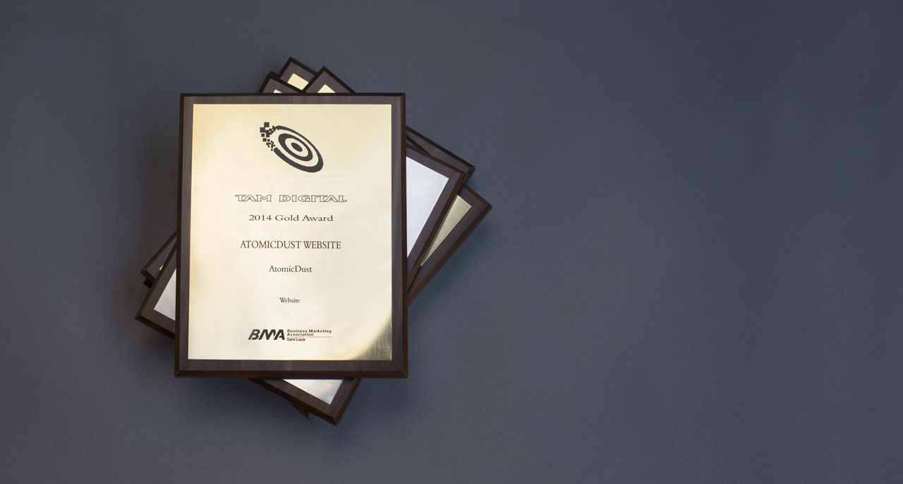 A stack of TAM awards for b2b branding and marketing