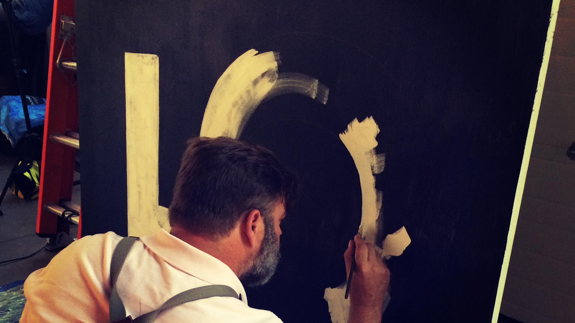 James Dixson paints a giant 5 on a canvas