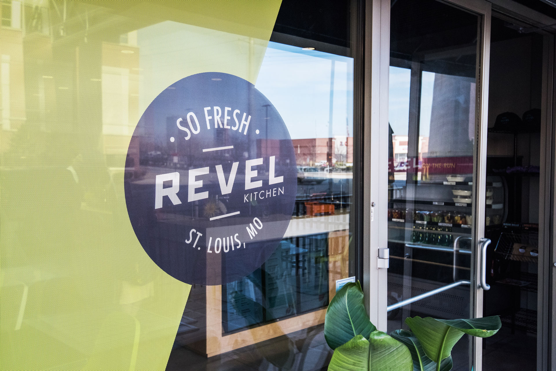 The branded window clings feature the new logo design at Revel Kitchen in St. Louis