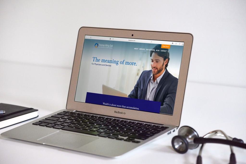 An open laptop with the new Thomas Wiring Doll marketing website on its screen