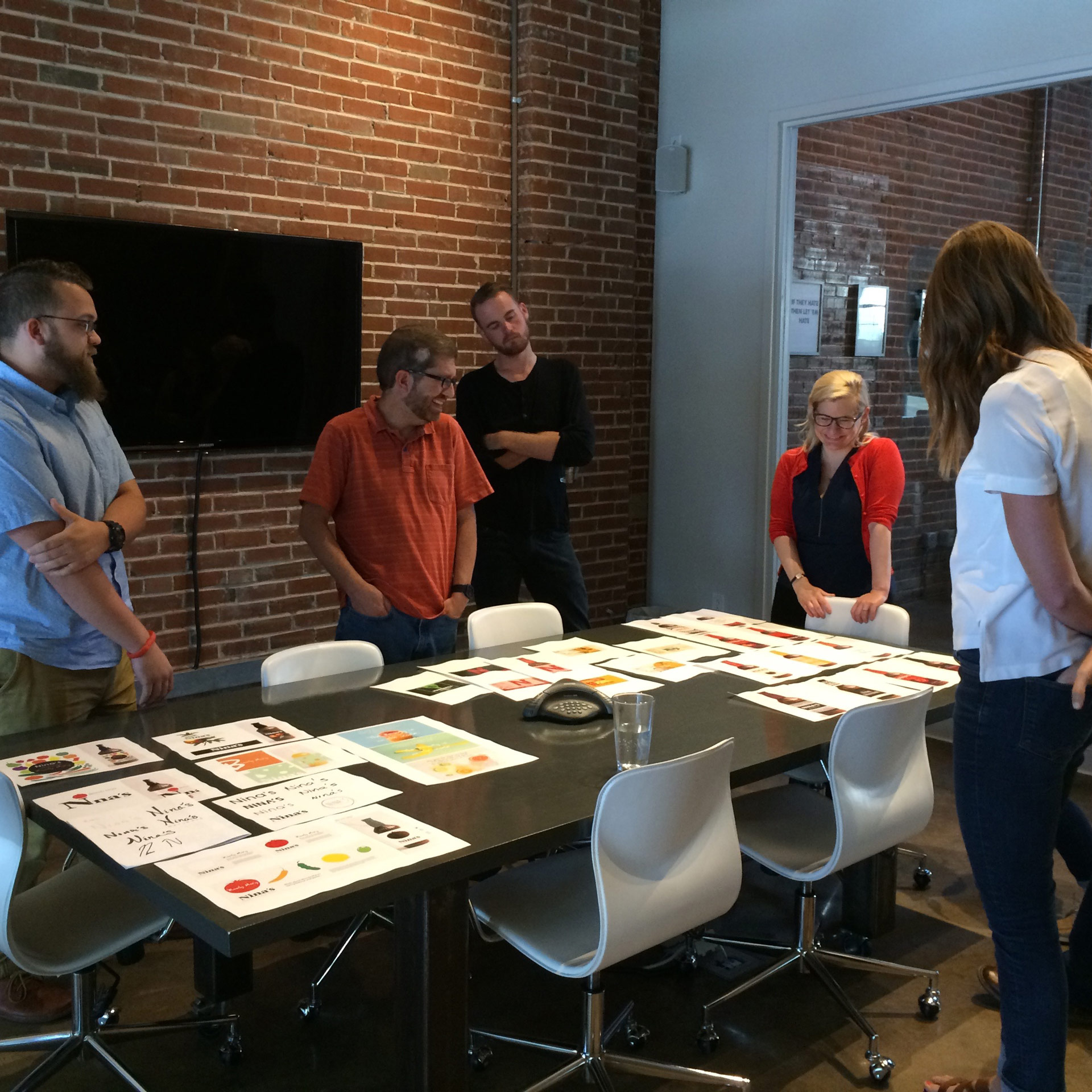 Creatives at Atomicdust Discussing the Nina's Natural Branding Concepts