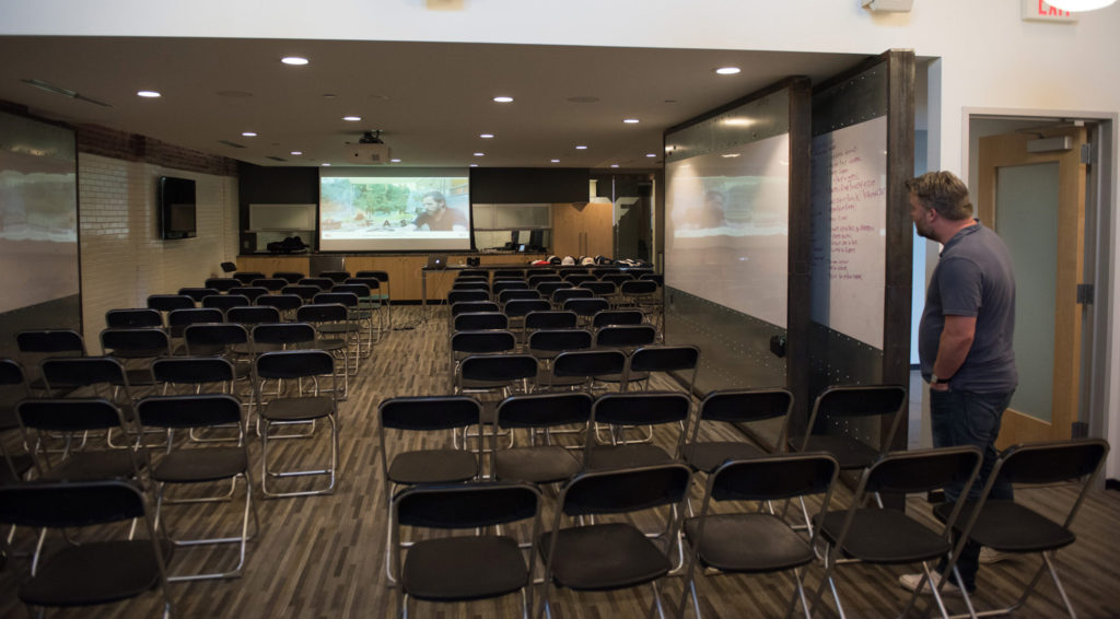 Mike Spakowski looks at a room full of empty chairs