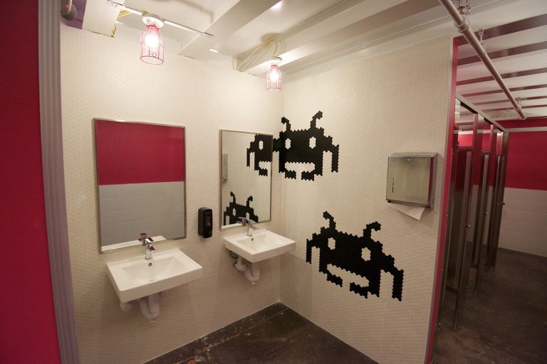 The branded restroom tile at Start Bar