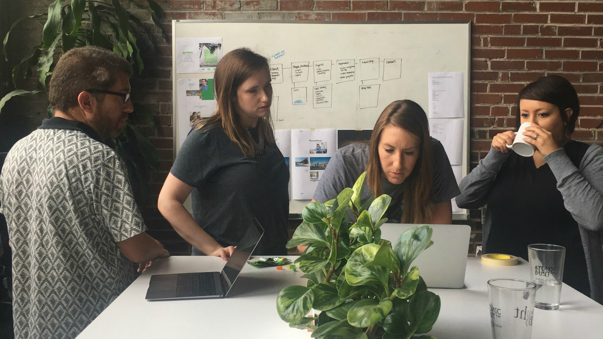 Designers and Writers collaborate at Atomicdust on a brand identity project.