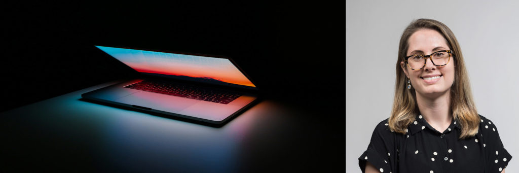 Atomicdust Senior Designer Amanda Pickens and a glowing laptop in the dark