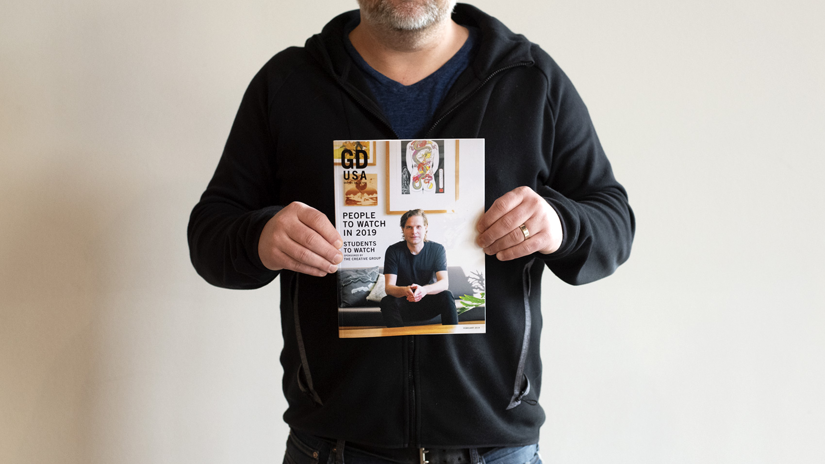 Mike Spakowski holds the 2019 People to Watch issue of Graphic Design USA