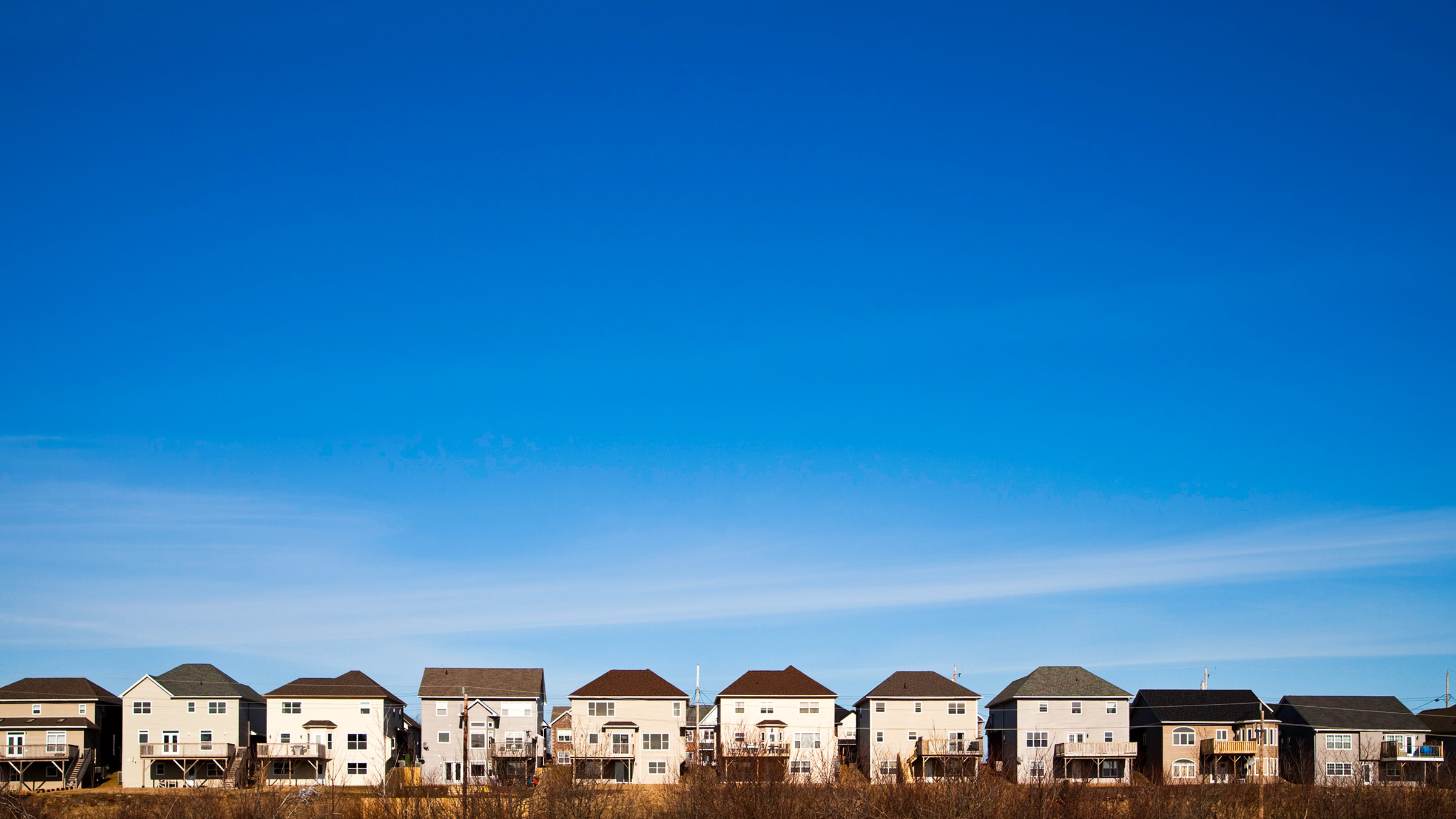A row of houses beneath the blue sky