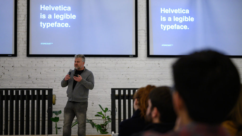 Mike Spakowski speaks before Atomicdust's screening of Helvetica
