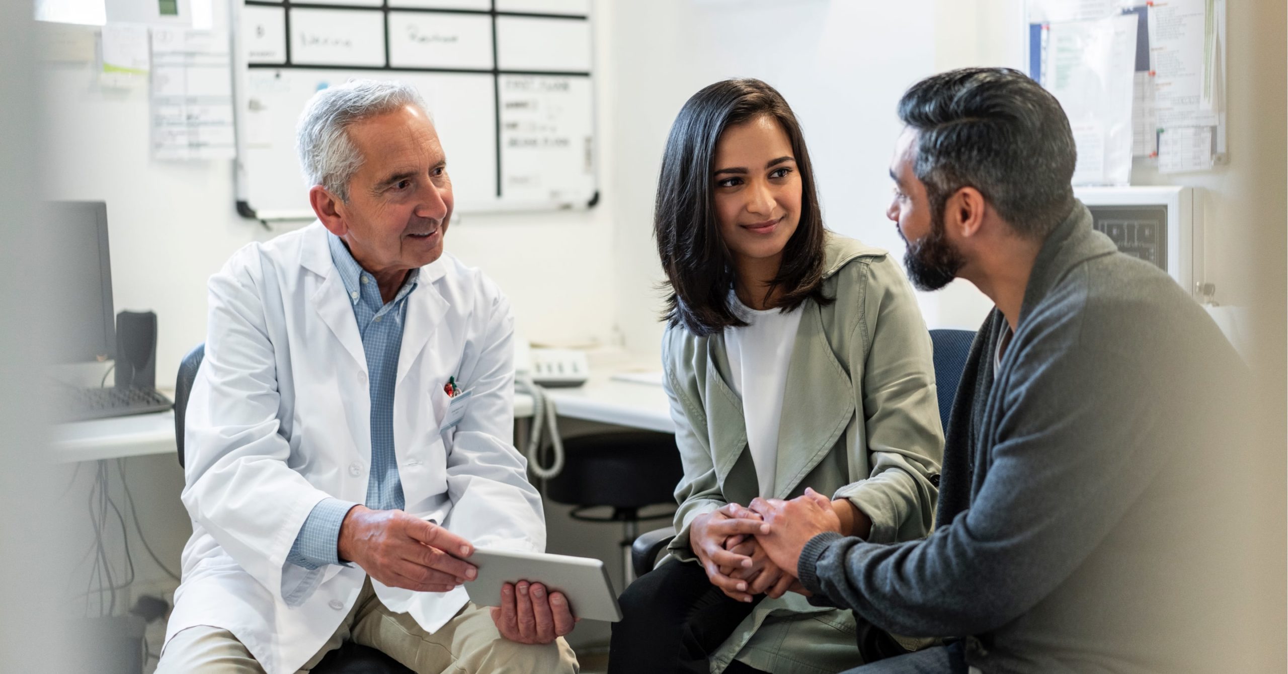 A doctor meets with patients