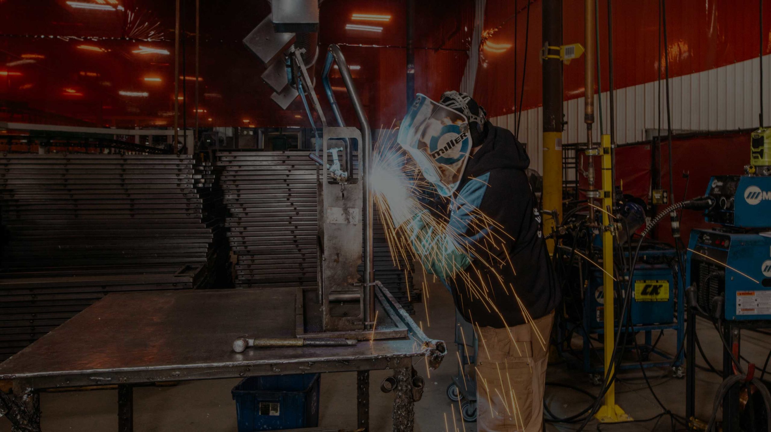 A welder manufactures a cart at National Cart Co.