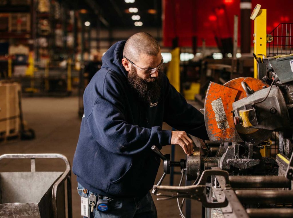 A National Cart Co. employee works on manufacturing a cart