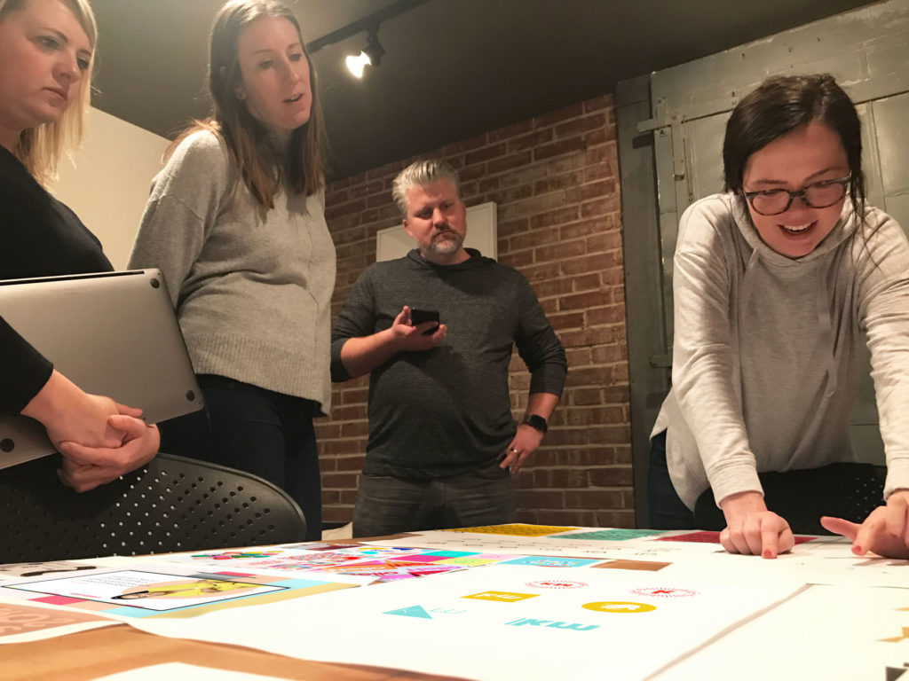 Atomicdust team members discuss design options for Keisha Mabry's branding