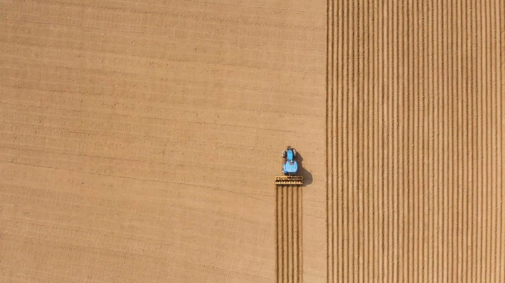 A tractor harvests fields of crop, a metaphor for content marketing