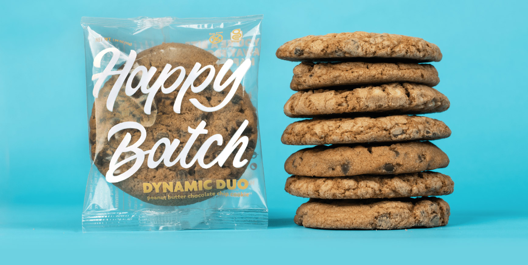 Stack of Happy Batch cookies next to a Happy Batch in the package