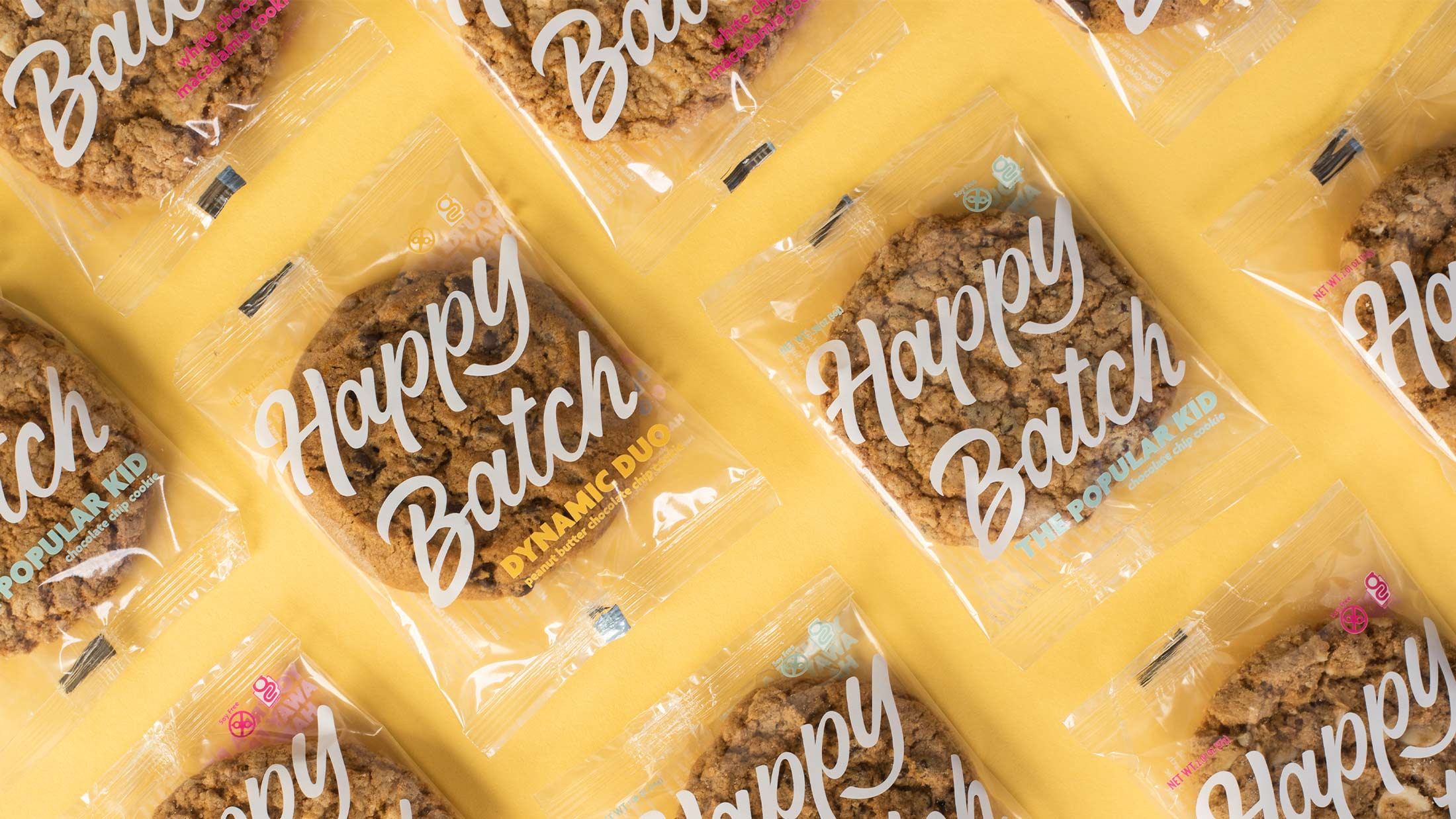 Happy Batch cookie packaging designs against a yellow background