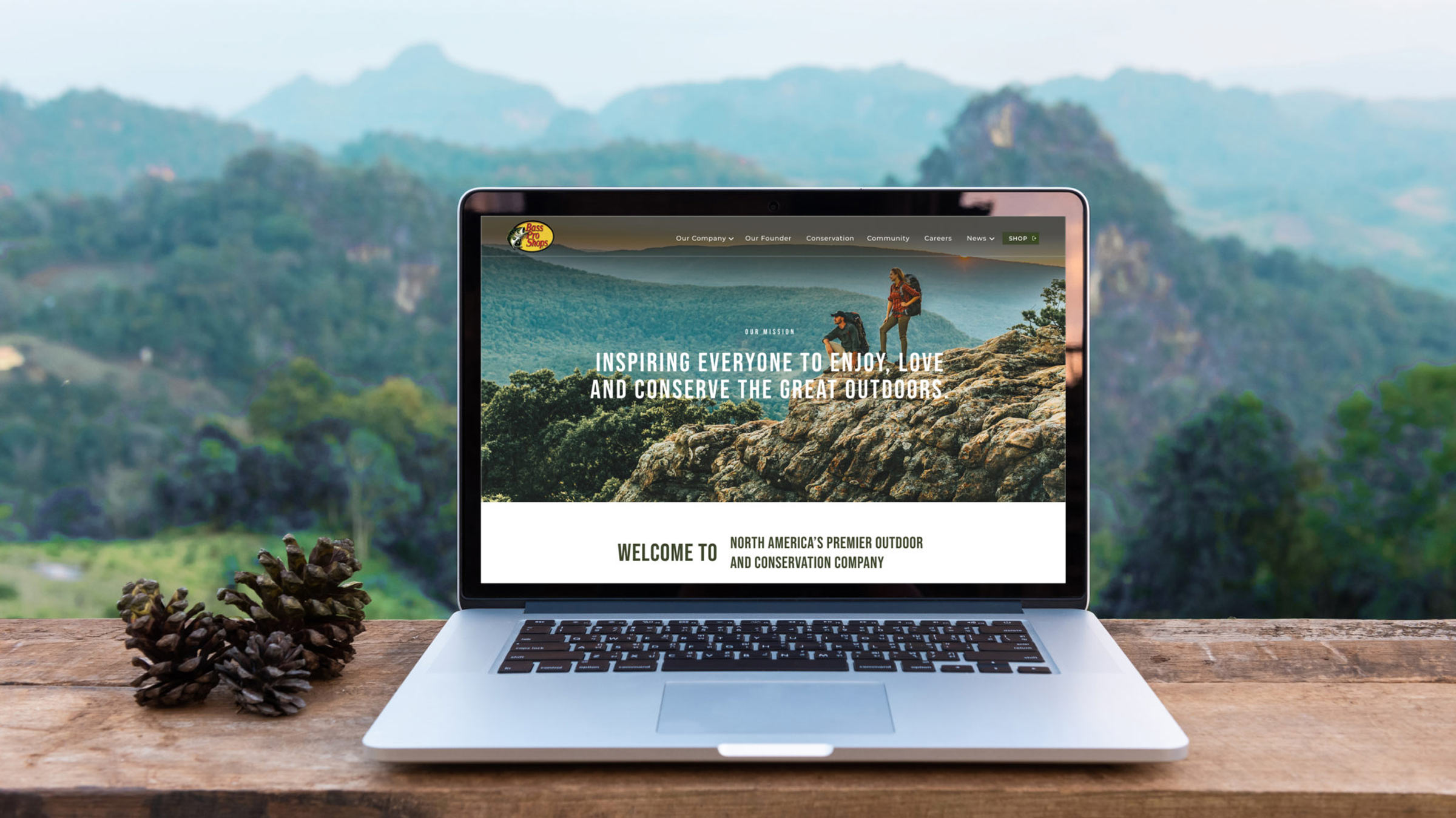 Bass Pro Shops brand page website design on a laptop in the mountains