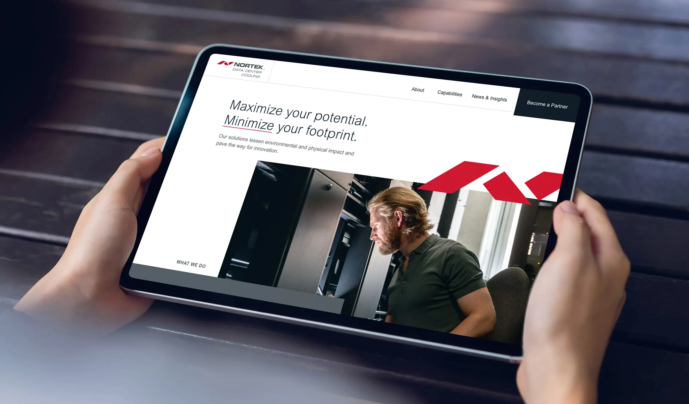 A person looks at the Nortek Data Center Cooling website design on a tablet