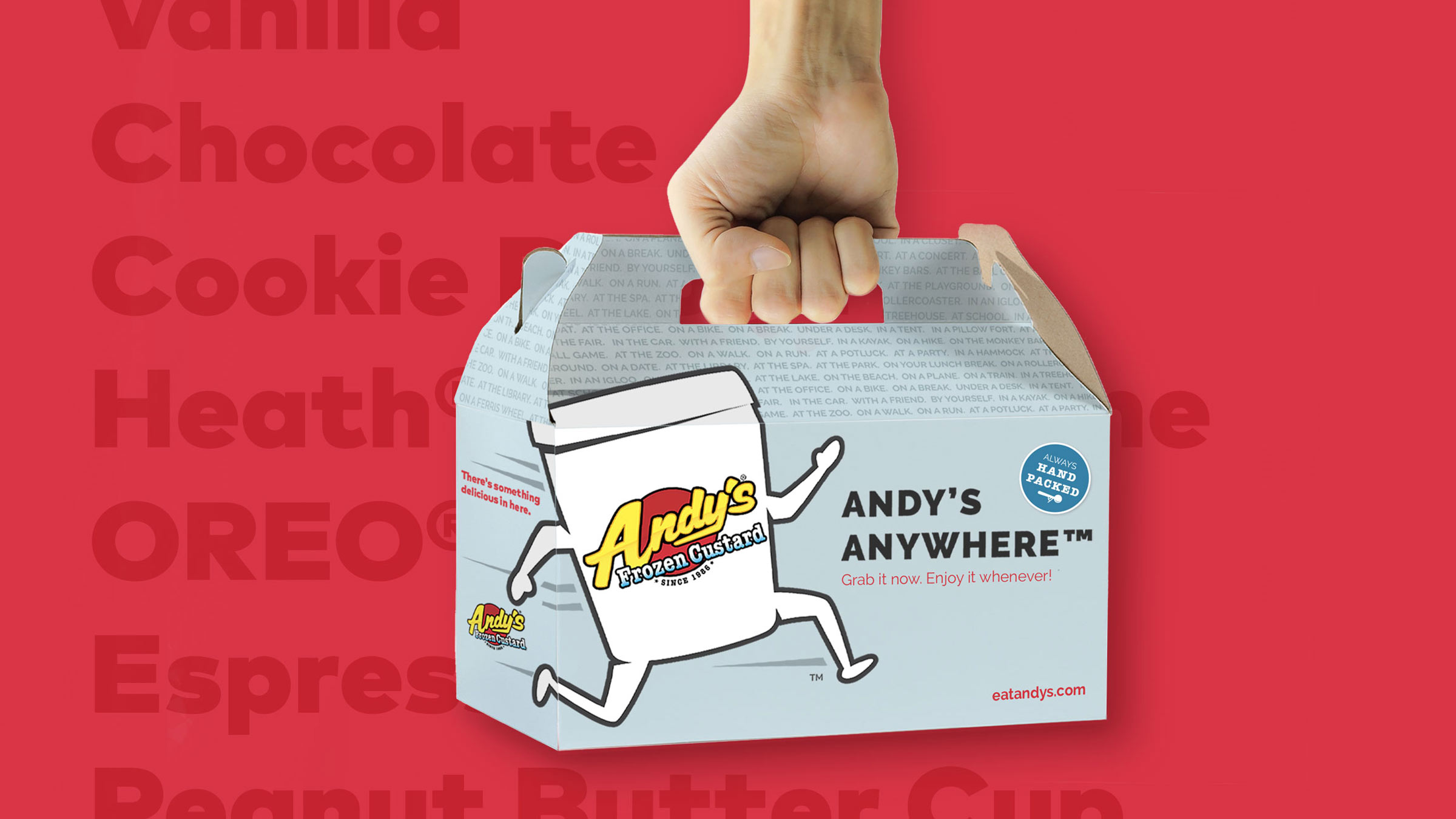 A hand holds the Andy's Anywhere Pick 6 carrier case with Atomicdust's packaging design
