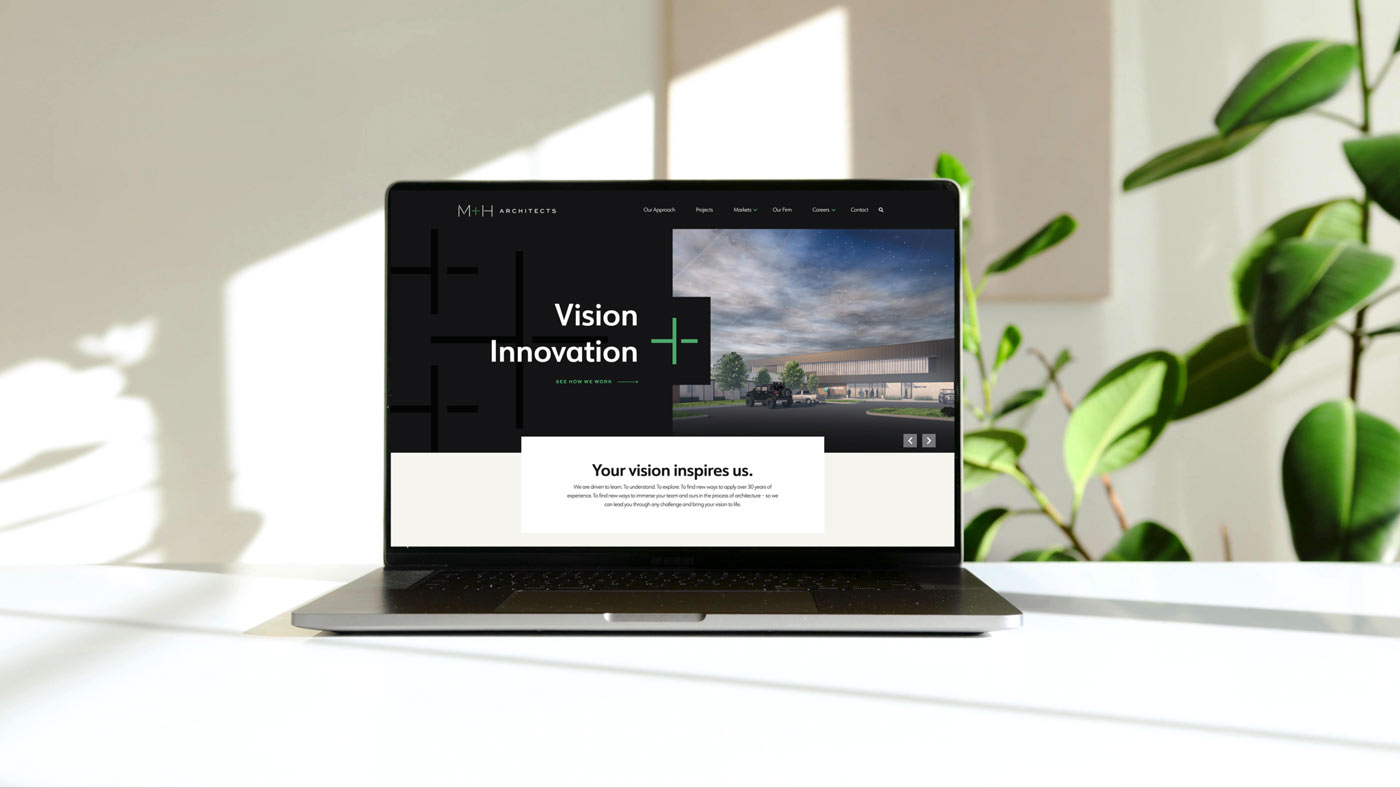 A laptop with the new M+H Architects website design