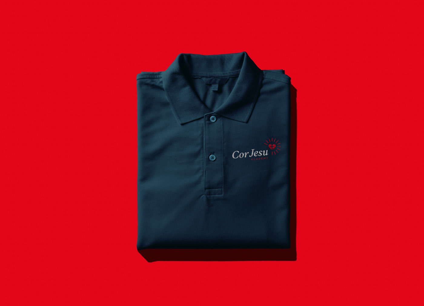 A uniform polo featuring Cor Jesu's new logo