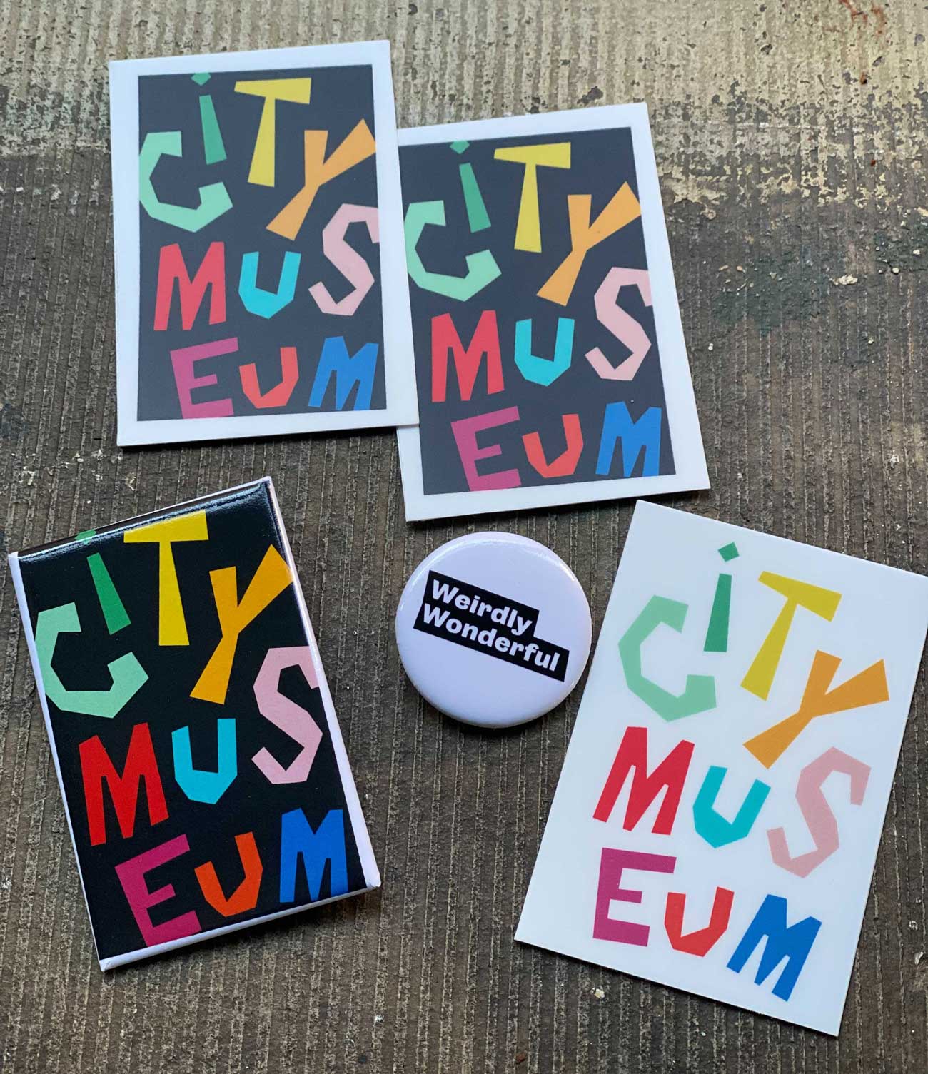 City Museum branding on new merch, including stickers, buttons and magnets