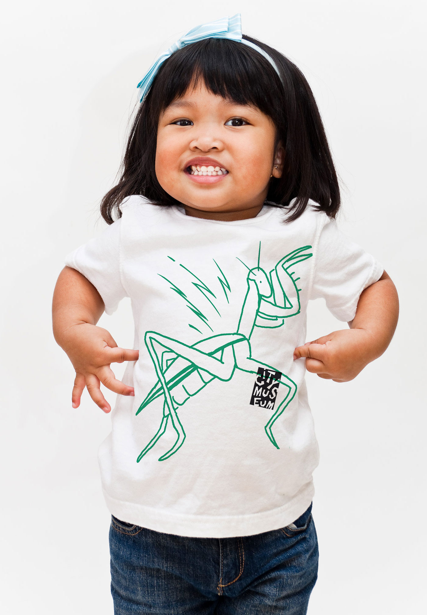 A little girl wears a t-shirt with City Museum's new branding