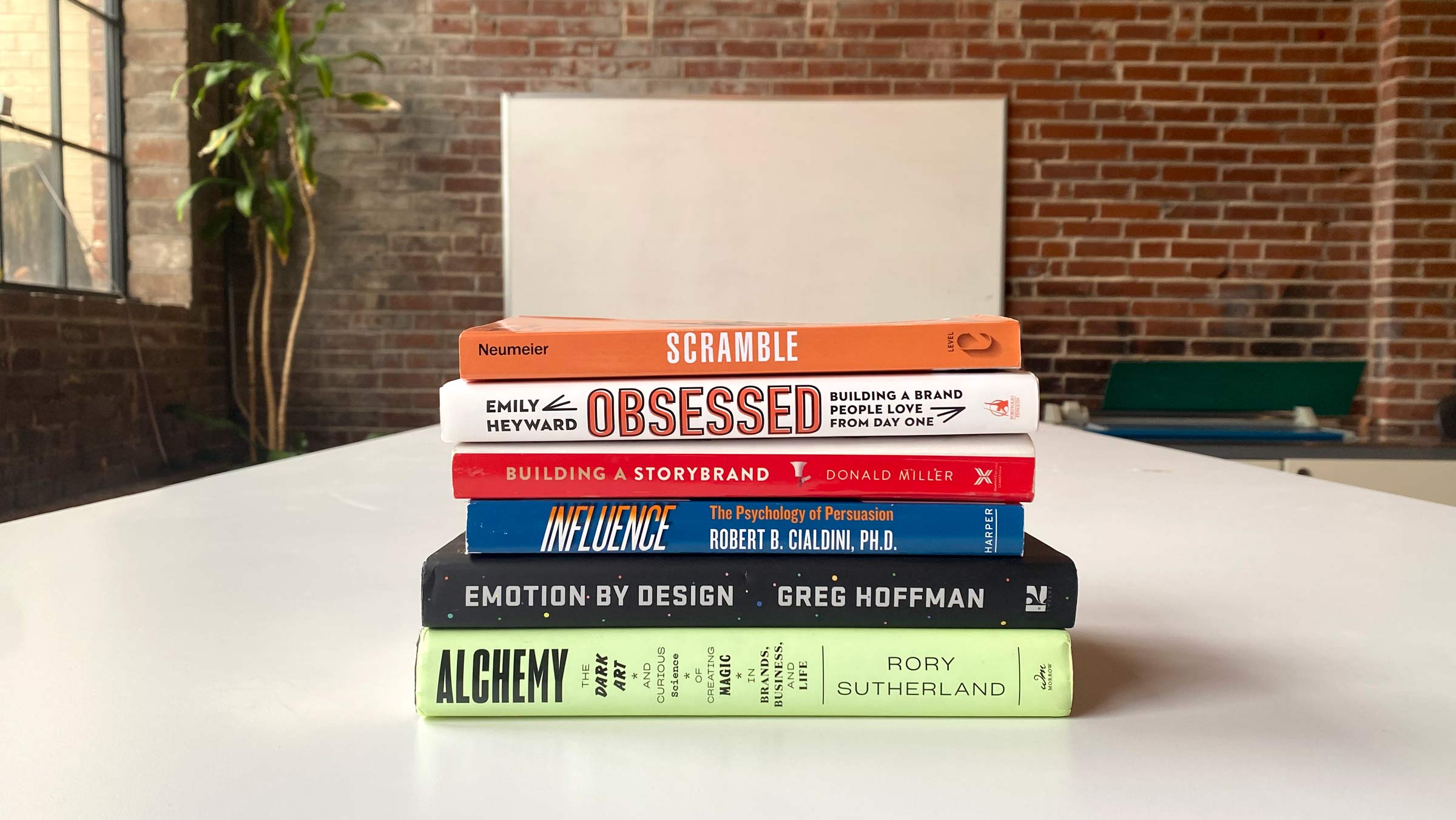 Some of the branding and marketing books the Atomicdust book club read in 2022, including Scramble, Obssessed, Influence and Building a StoryBrand