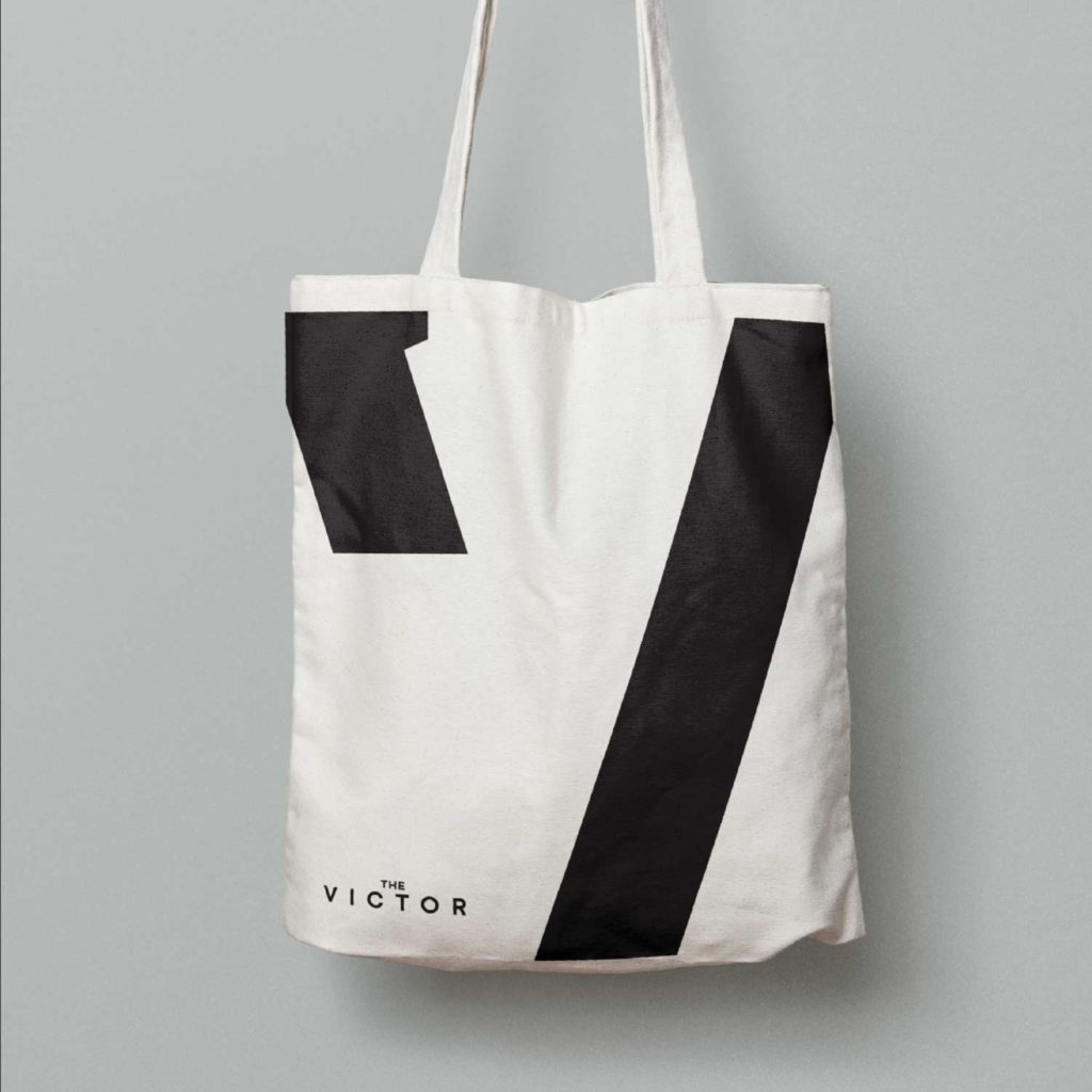 The Victor residential development branding on a tote bag