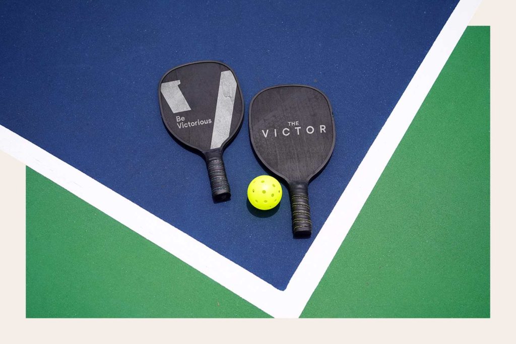 The Victor branding mocked up on pickleball paddles. The Victor's rooftop will include a pickleball court.