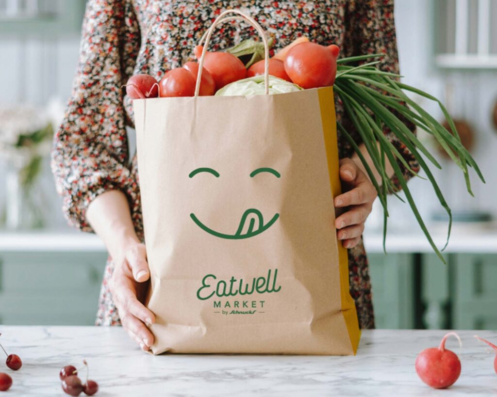 Eatwell Market branding on a paper grocery bag