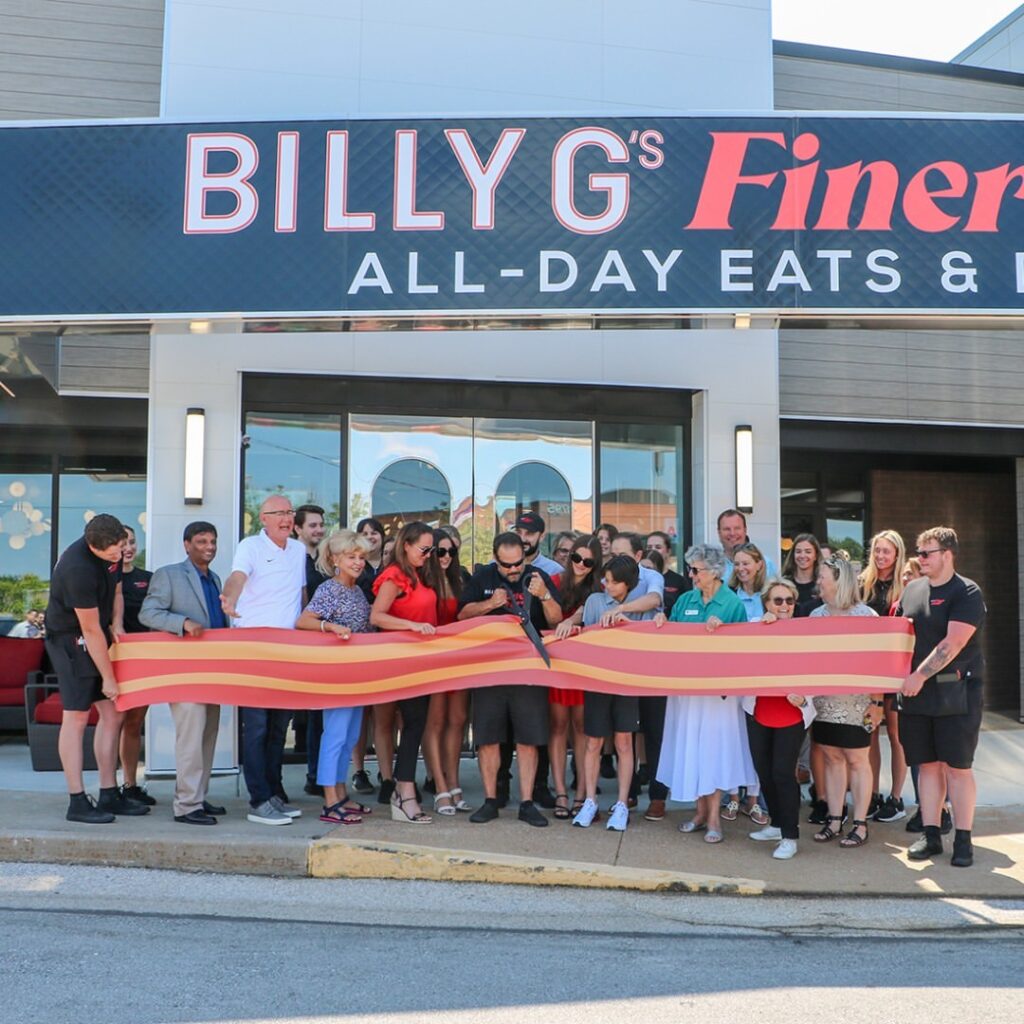 The Billy G's team does a grand opening ribbon cutting with a paper strip of bacon as the ribbon