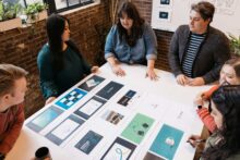 The Atomicdust team reviews an in-progress healthcare branding and web design project
