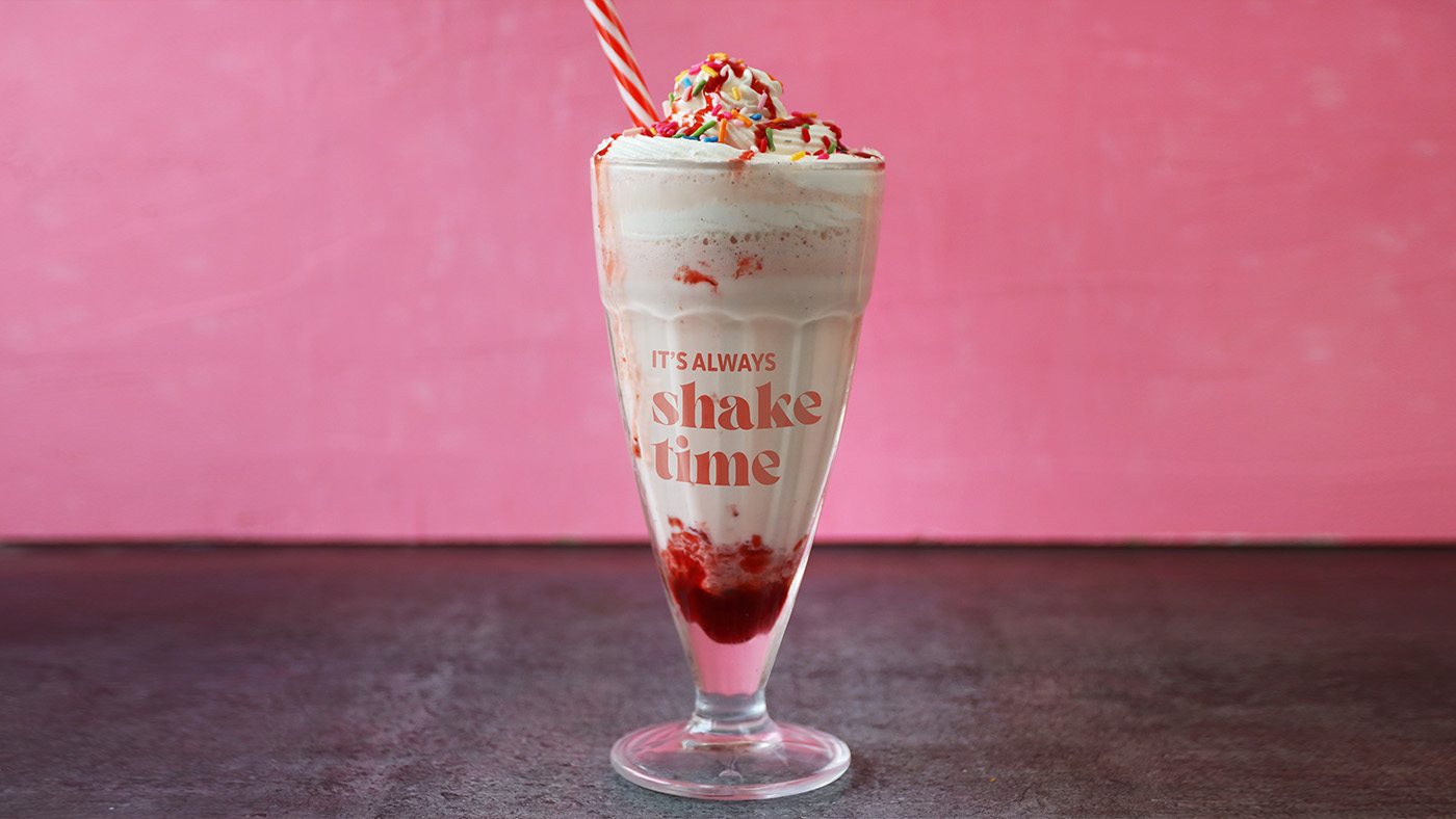 Creative expression showing the Billy G's Finer Diner branding on a milkshake glass, with the words "It's always shake time."