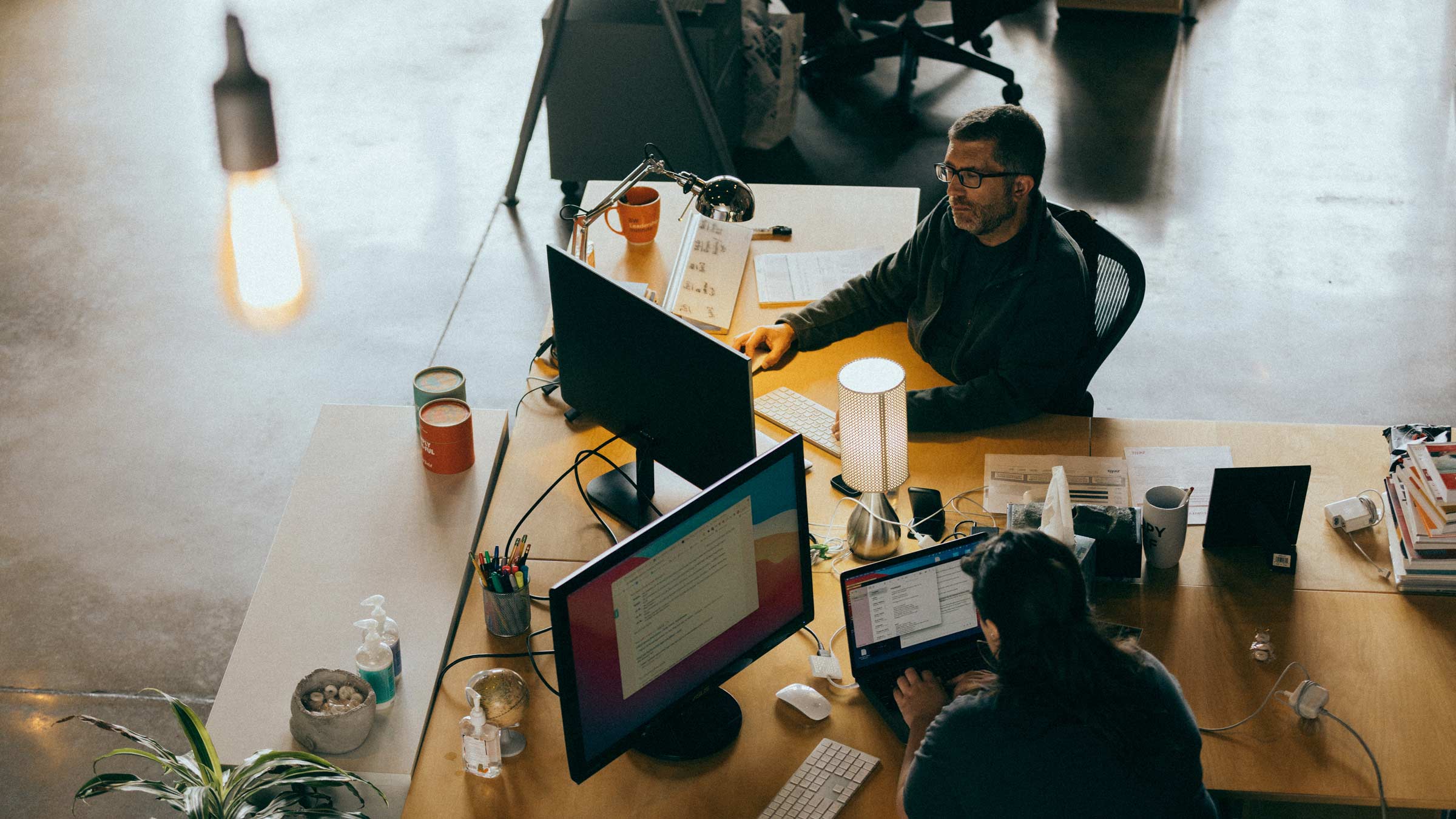 Photo from above of Atomicdust team members working in the office