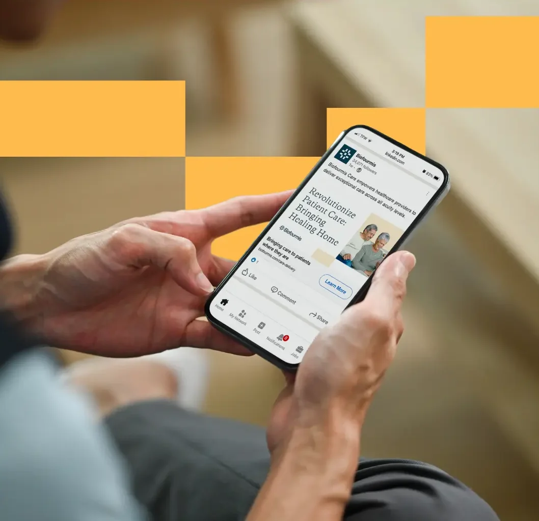 Person holding an iPhone showing the Biofourmis website designed by Atomicdust