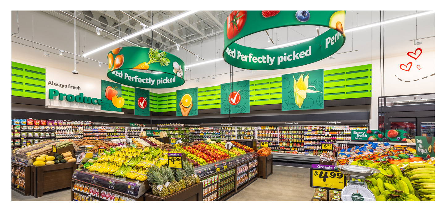Environmental branding and signage inside a Winn-Dixie produce section
