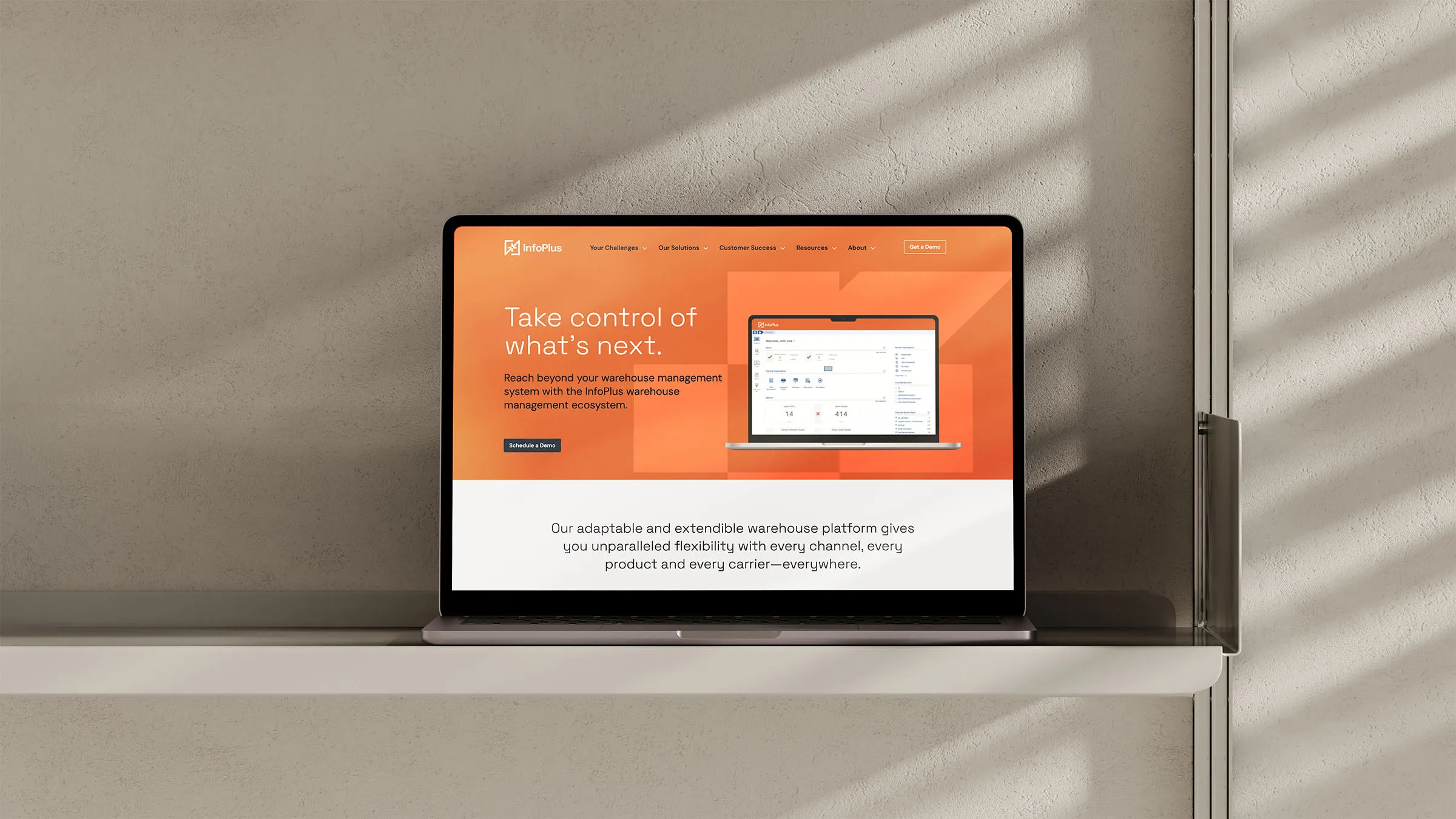 A laptop with the website design for InfoPlus, a warehouse management ecosystem