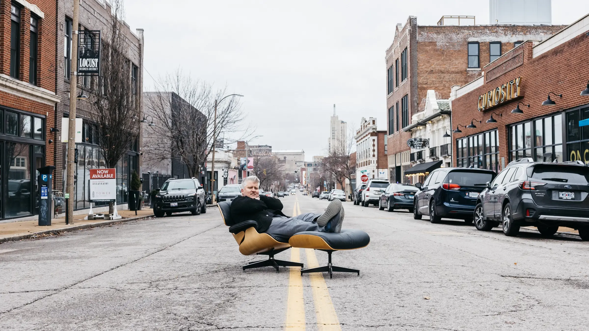 Mike Spakowski sits on an Eames chair in the middle of Locust Street in Midtown St. Louis