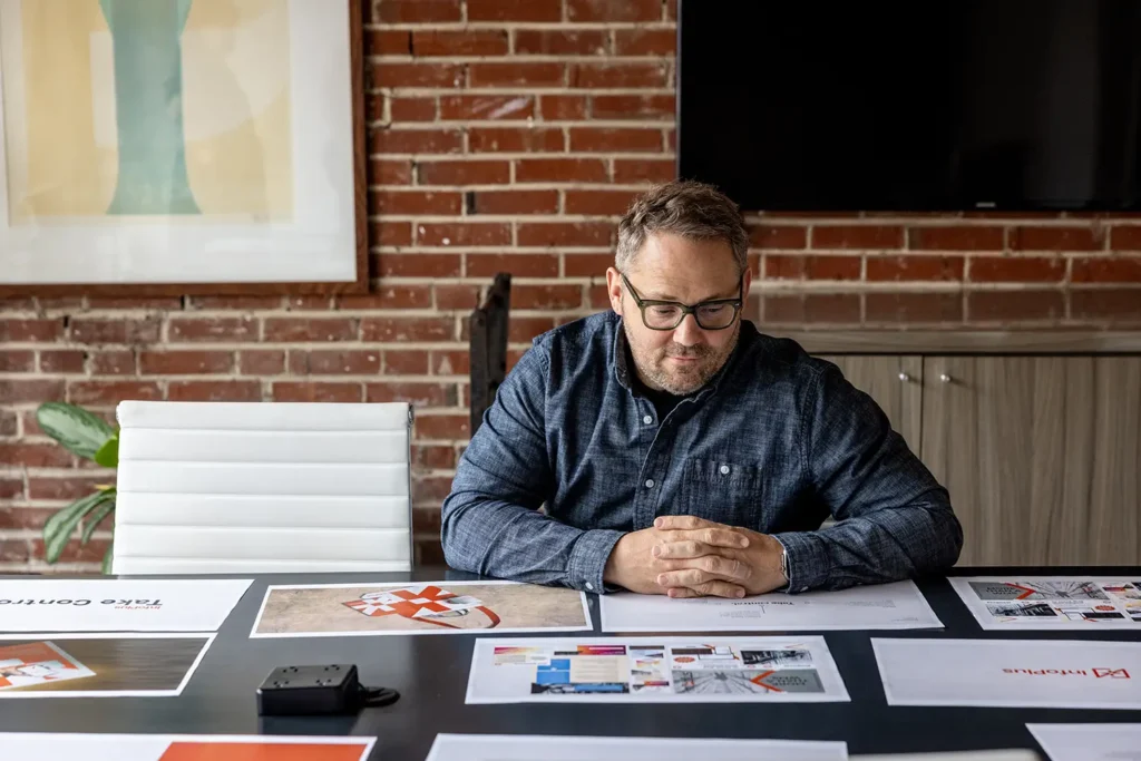 Atomicdust Partner Jesse McGowan reviewing brand identity