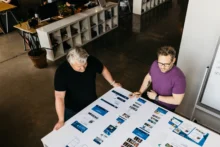 Mike Spakowski and Jesse McGowan review branding inside Atomicdust branding and marketing agency
