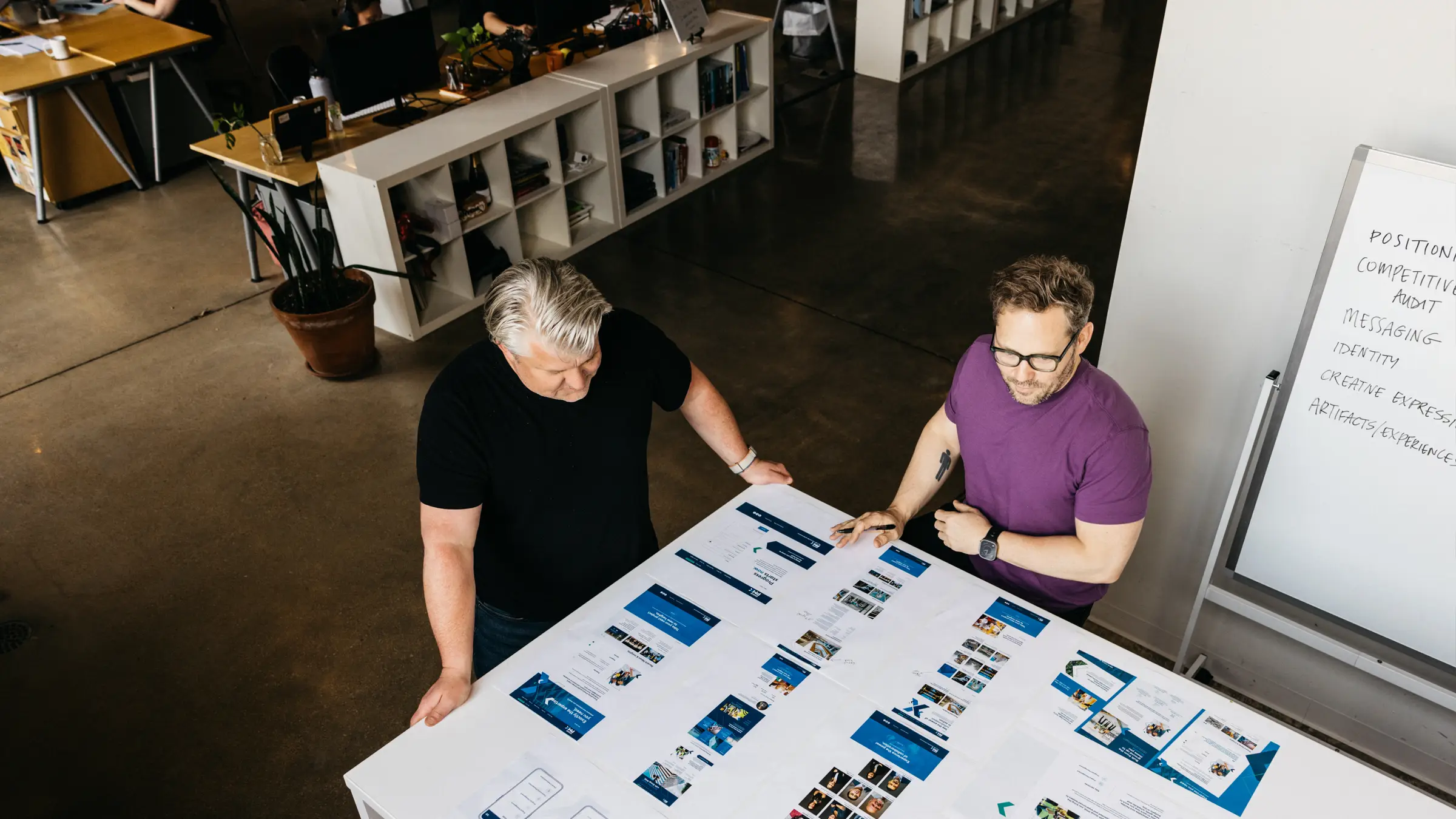 Mike Spakowski and Jesse McGowan review branding inside Atomicdust branding and marketing agency