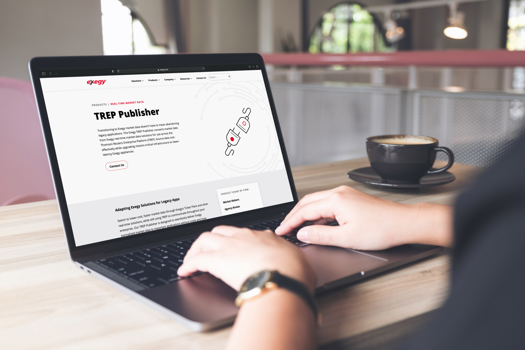A person looks at Exegy's fintech web design on a laptop