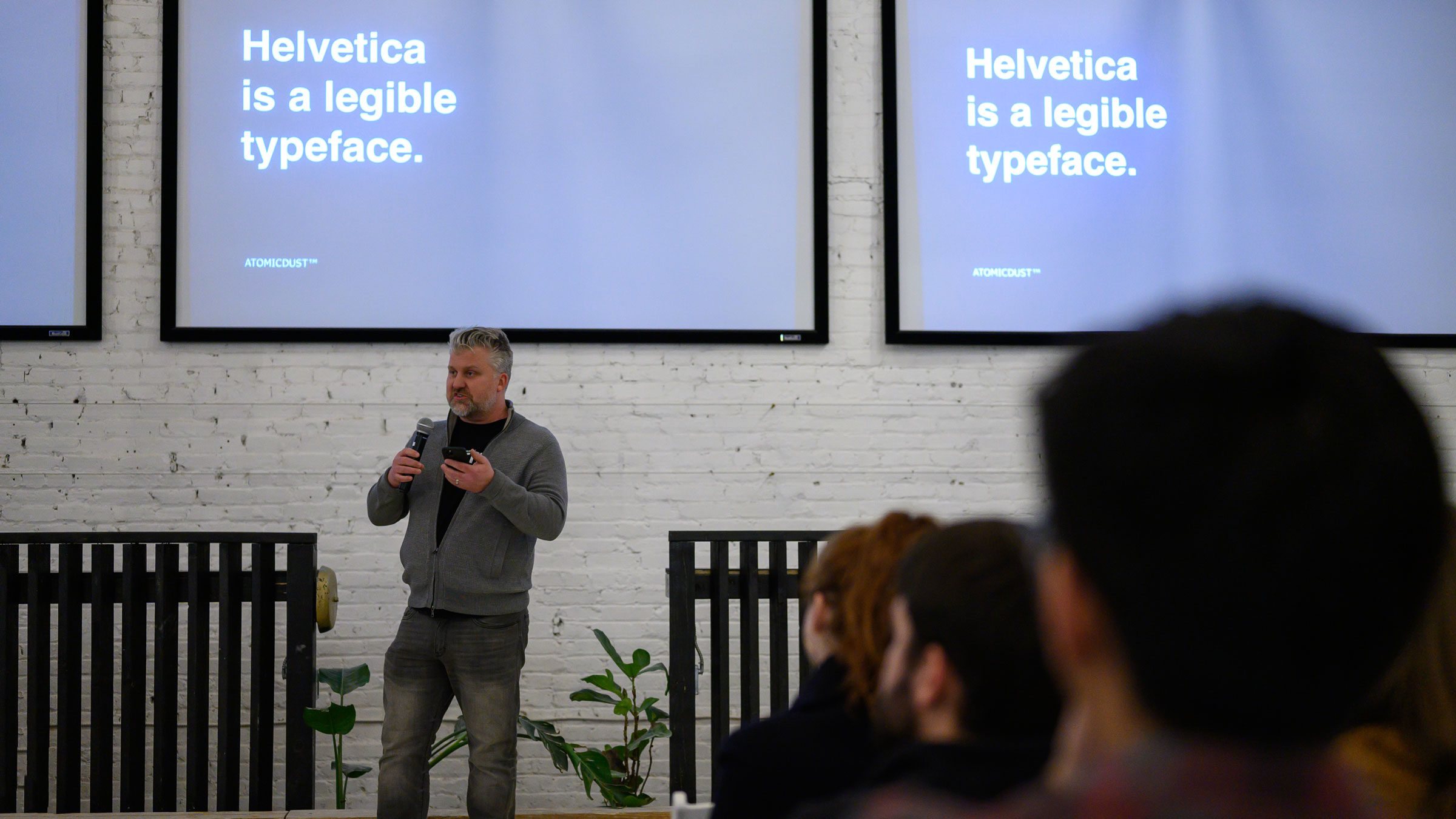 Mike Spakowski speaks before Atomicdust's screening of Helvetica
