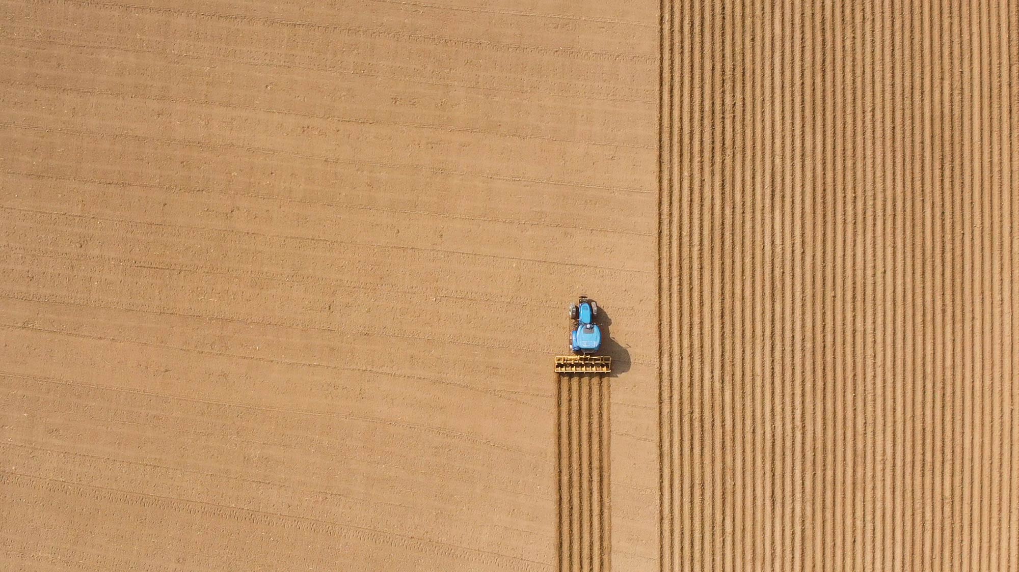 A tractor harvests fields of crop, a metaphor for content marketing